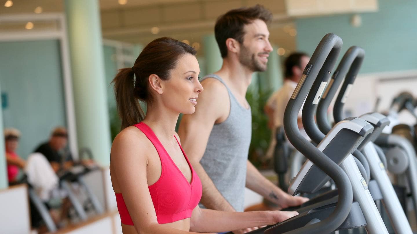 Woman working out in a gym without talking to anyone